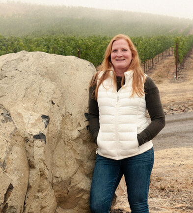 Heidi Bridenhagen in front of Nightwing Vineyard