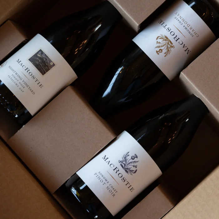 Three bottles of MacRostie wines in a shipping box.