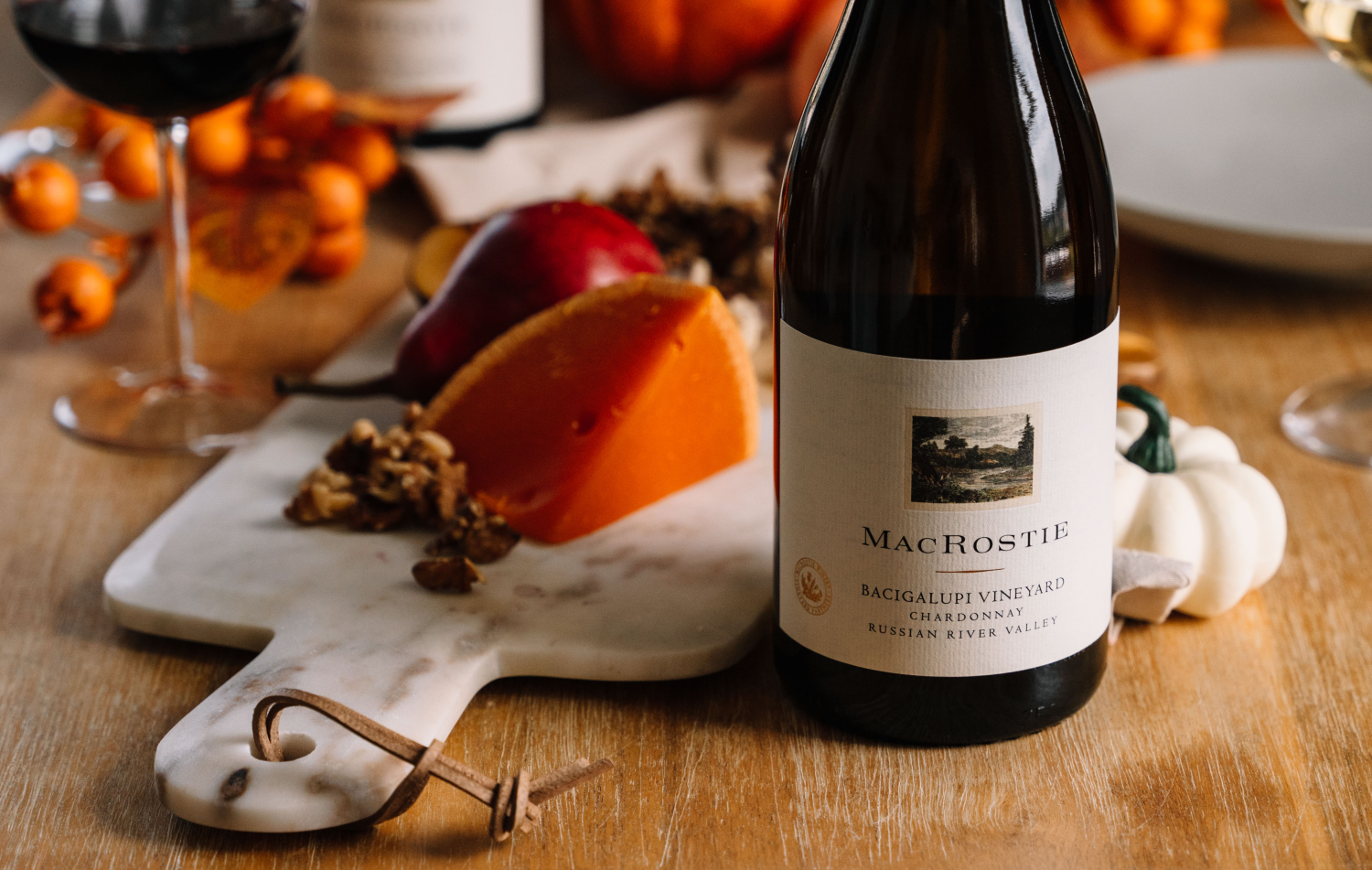 A bottle of Bacigalupi Chardonnay next to food pairings and table decor