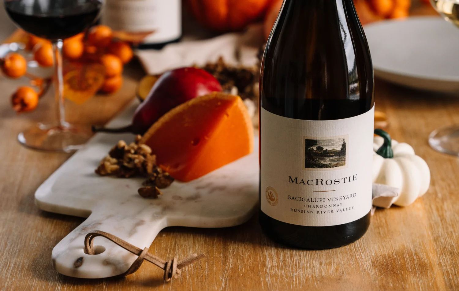 A bottle of Bacigalupi Chardonnay next to food pairings and table decor