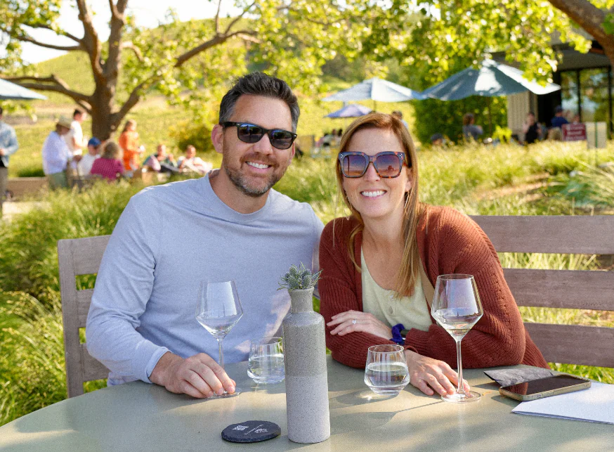 Couple sitting at a table outside the MacRostie Estate House