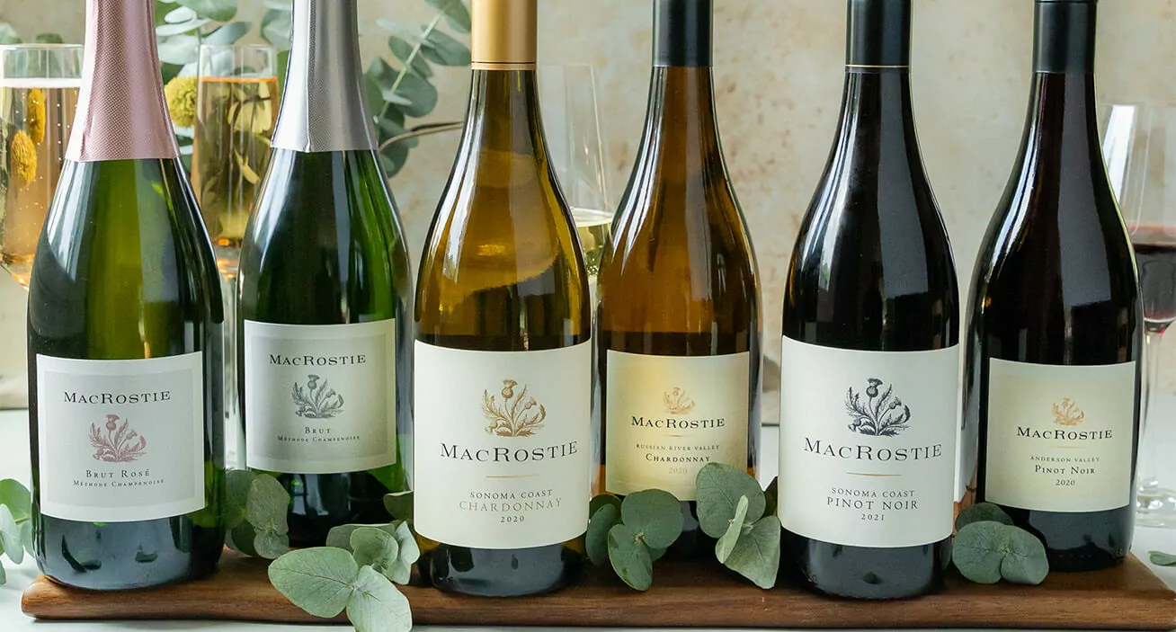 Six bottles of different MacRostie wines including Chardonnay, Pinot Noir, and sparkling wines.