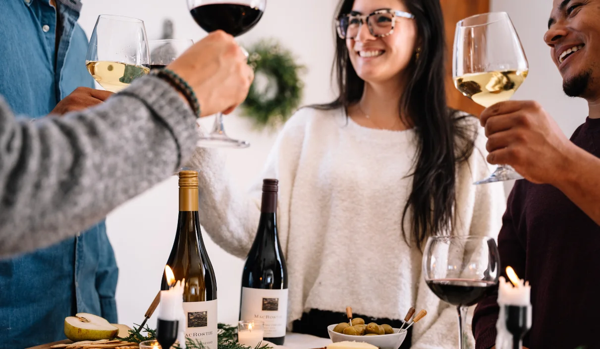 People cheersing at a table with MacRostie wine and food pairings