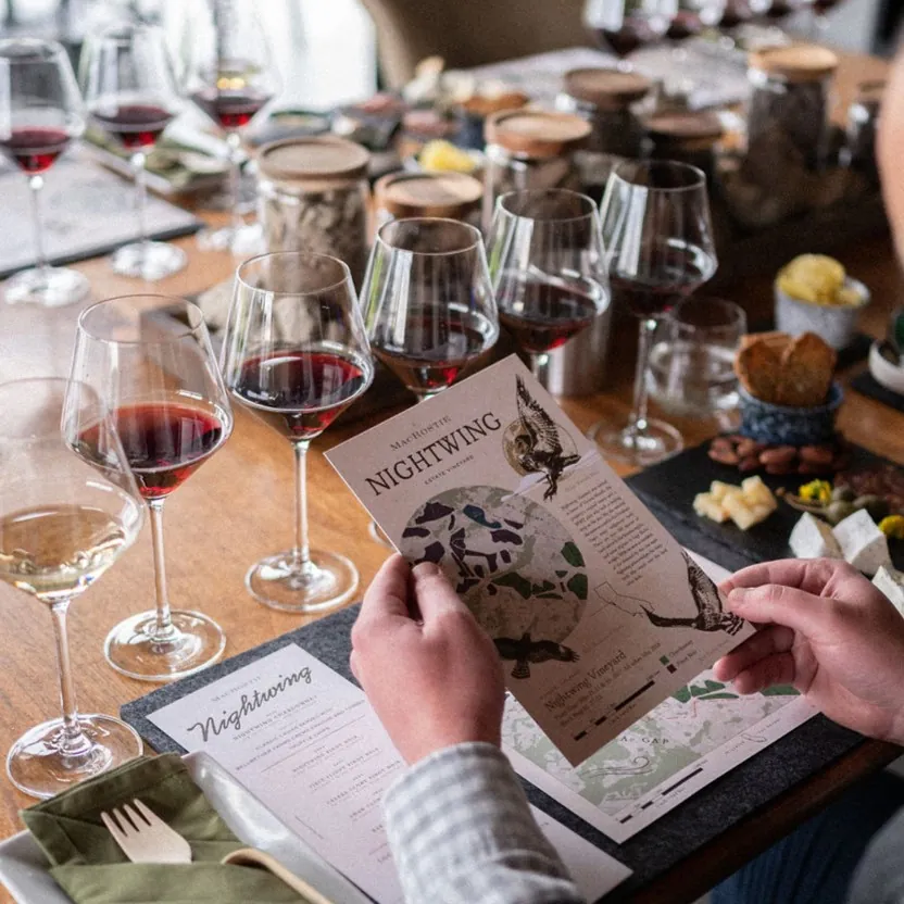 A guest holding a pamphlet during Nightwing Food & Wine Experience.