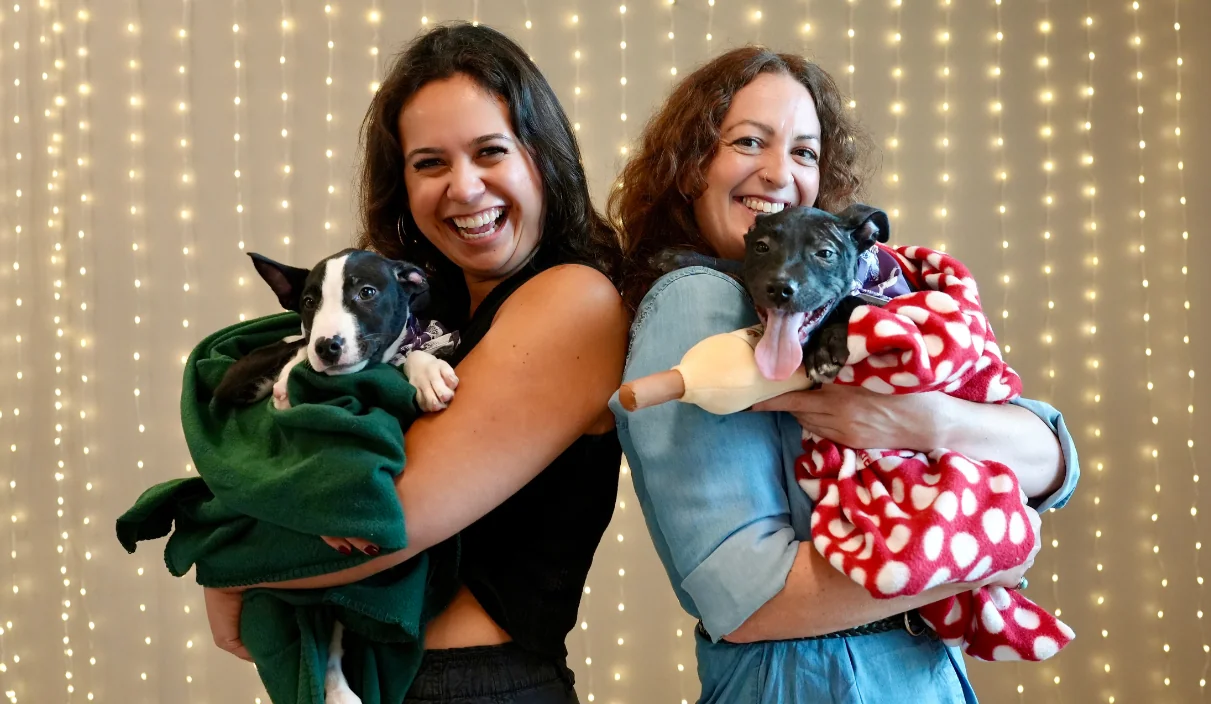MacRostie team members holding puppies