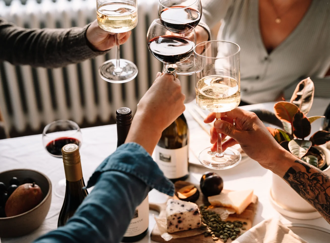 People cheersing at a table with MacRostie wines and food pairings
