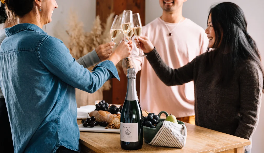 People cheersing around a table with MacRostie wine and food pairings