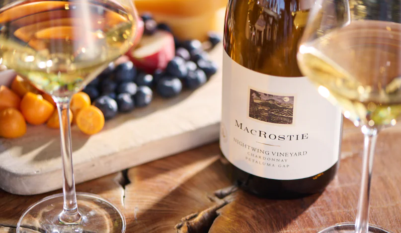 Bottle of MacRostie wine next to glasses of wine and food pairings
